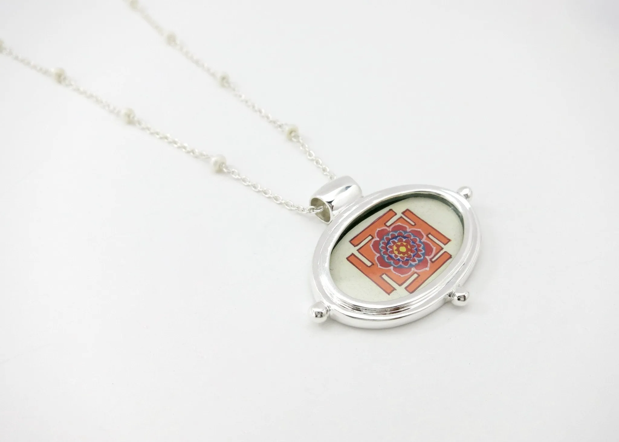 Exquisite, oval Lotus Yantra pendant on a floating pearl chain