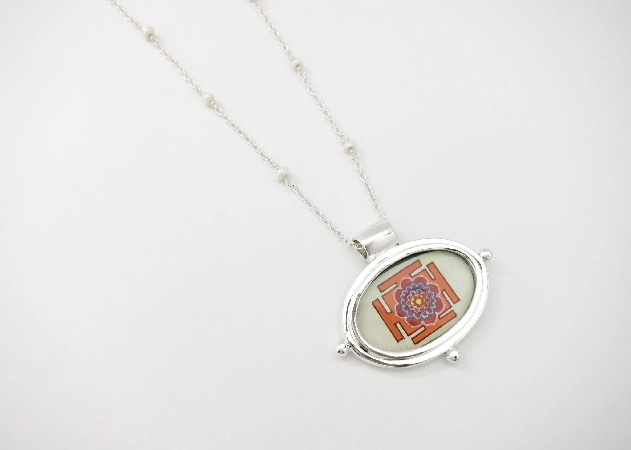 Exquisite, oval Lotus Yantra pendant on a floating pearl chain