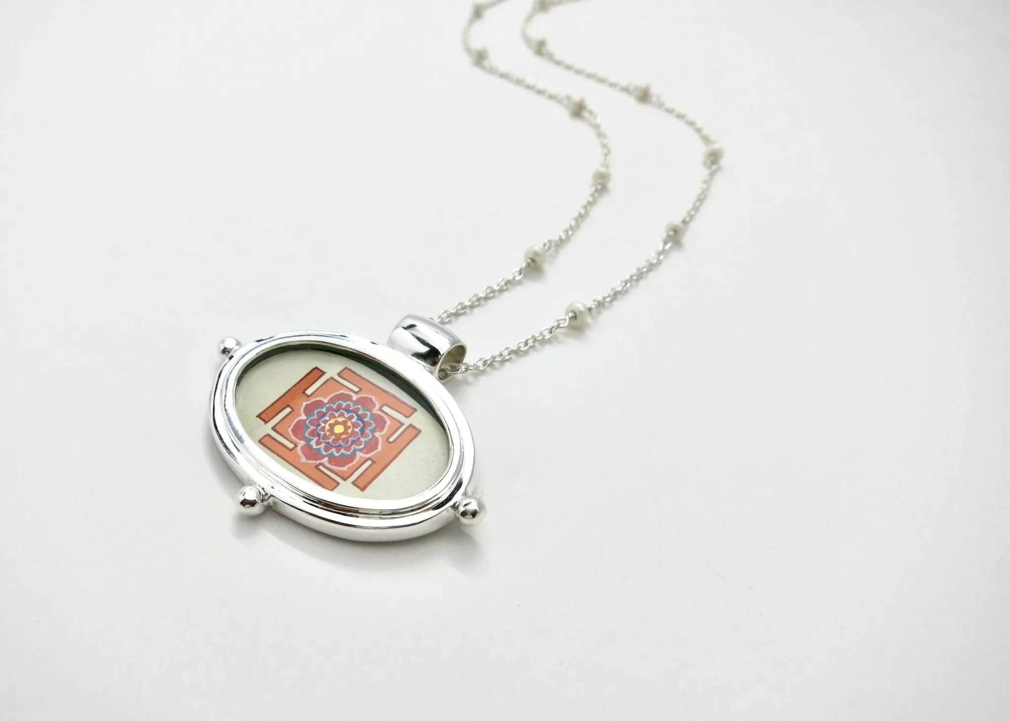 Exquisite, oval Lotus Yantra pendant on a floating pearl chain